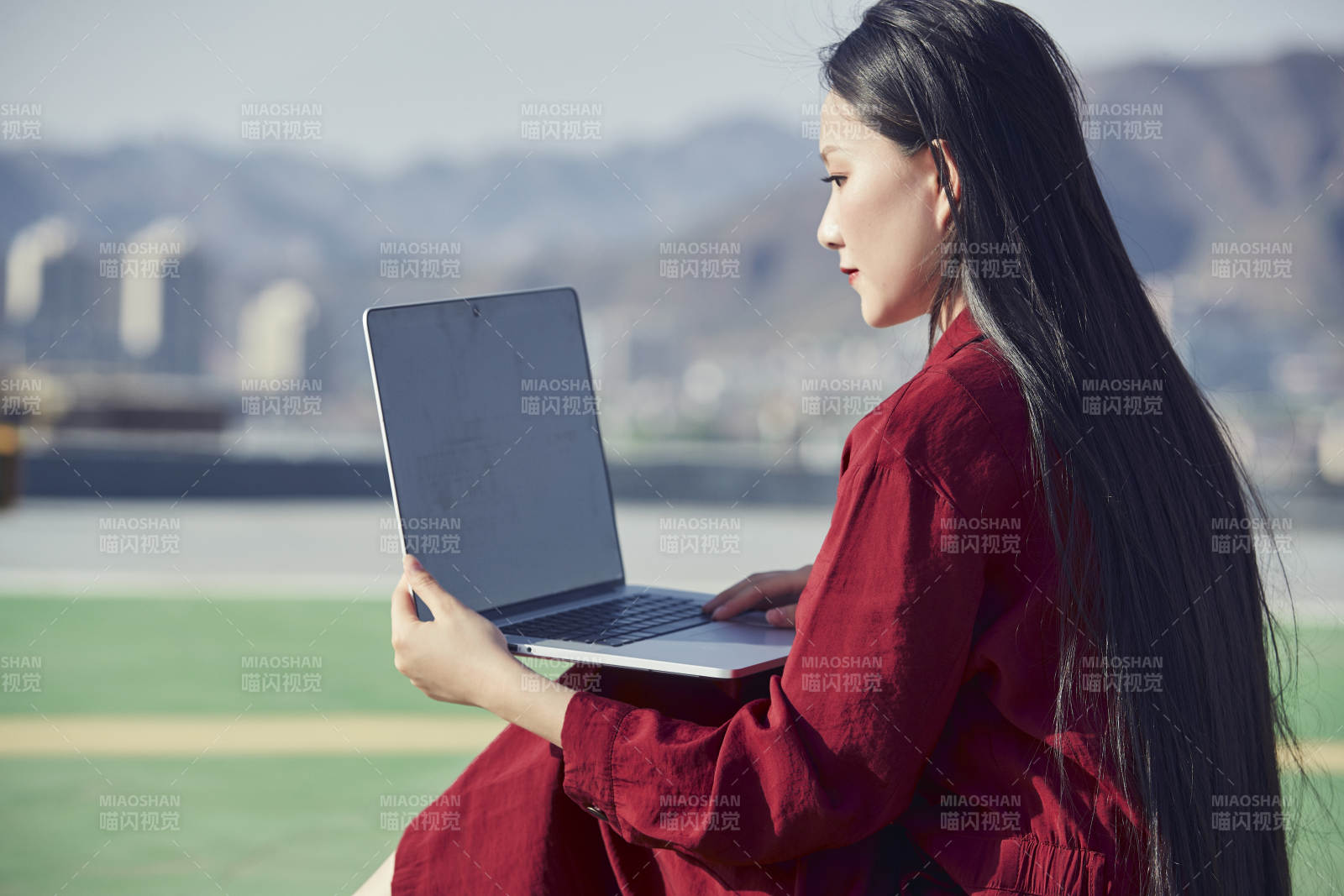 亚洲商务年轻女性在楼顶停机坪使用电脑办公图片