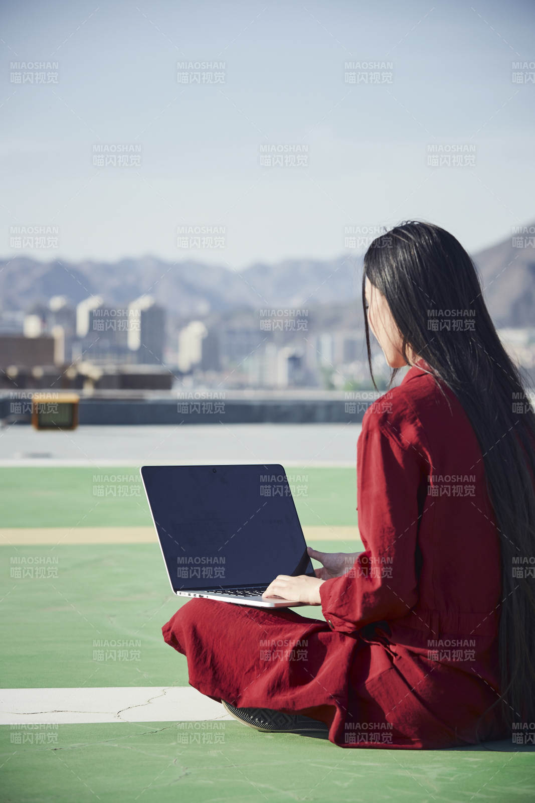 亚洲商务年轻女性在楼顶停机坪使用电脑办公图片