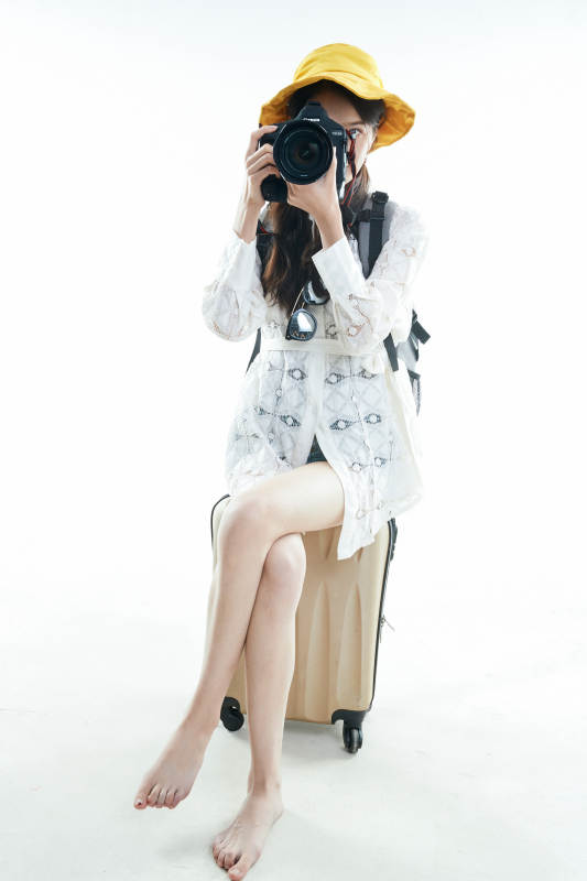 白色背景下准备出发旅行的美丽东方女大学生图片