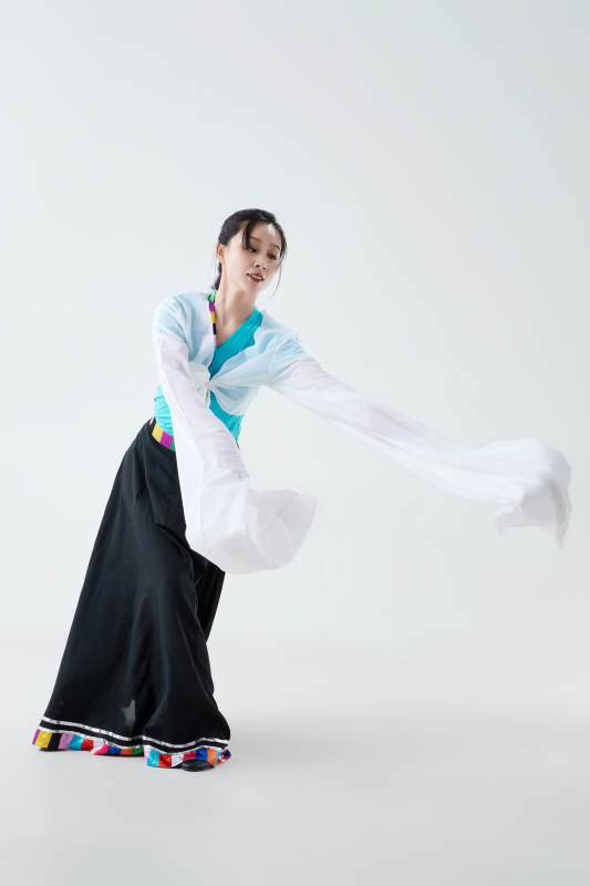 穿着藏族服饰跳着藏族舞蹈的少女图片