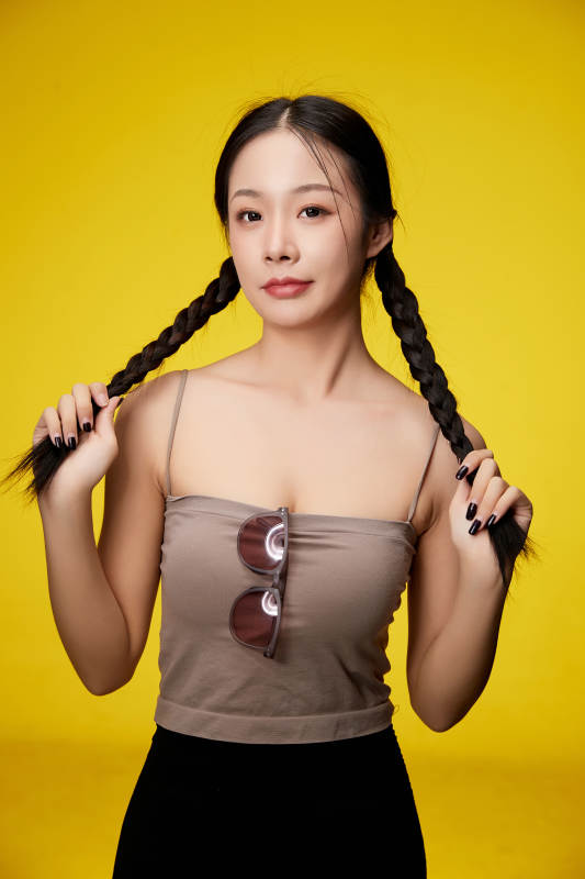 黄色背景下的活泼可爱女大学生图片