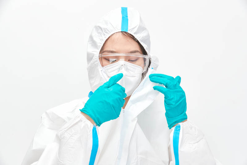 穿白色防护服佩戴护目镜口罩的女性医疗人员图片