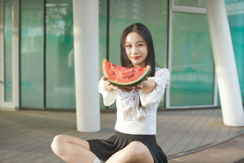 初夏户外公园吃西瓜的可爱少女图片