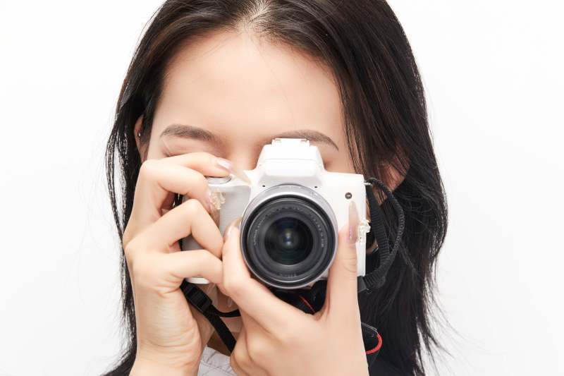 棚拍白色背景亚洲青年女性摄影师图片