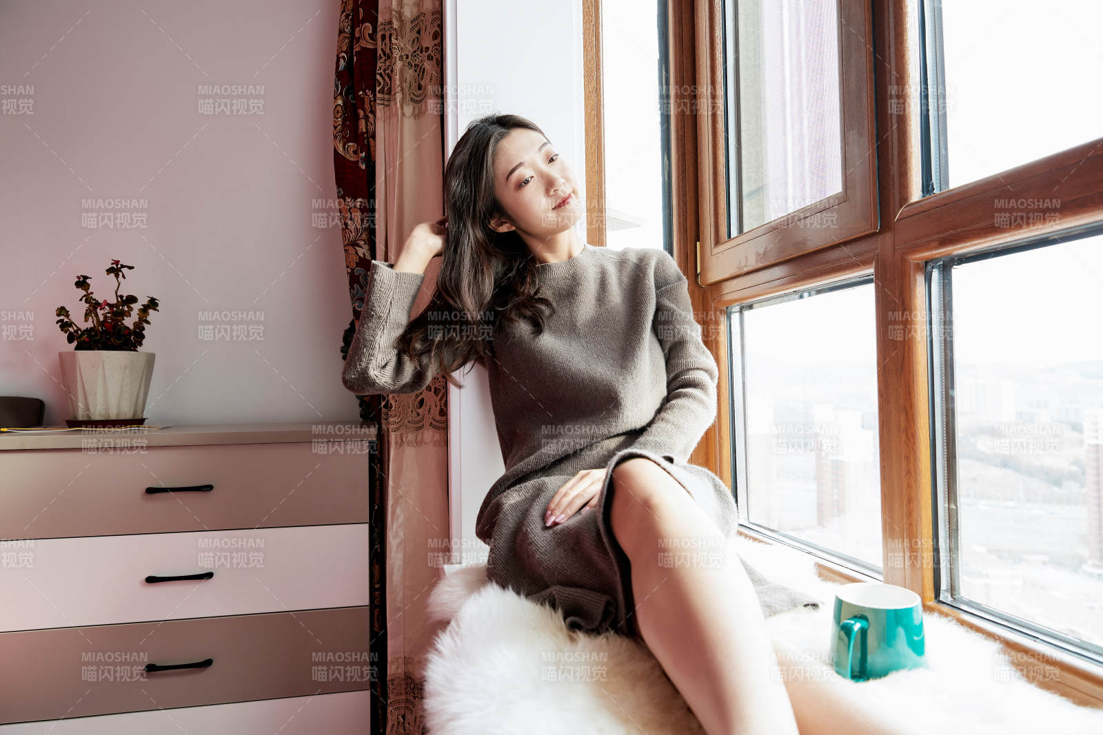 躺在舒适的飘窗上喝咖啡的少女图片