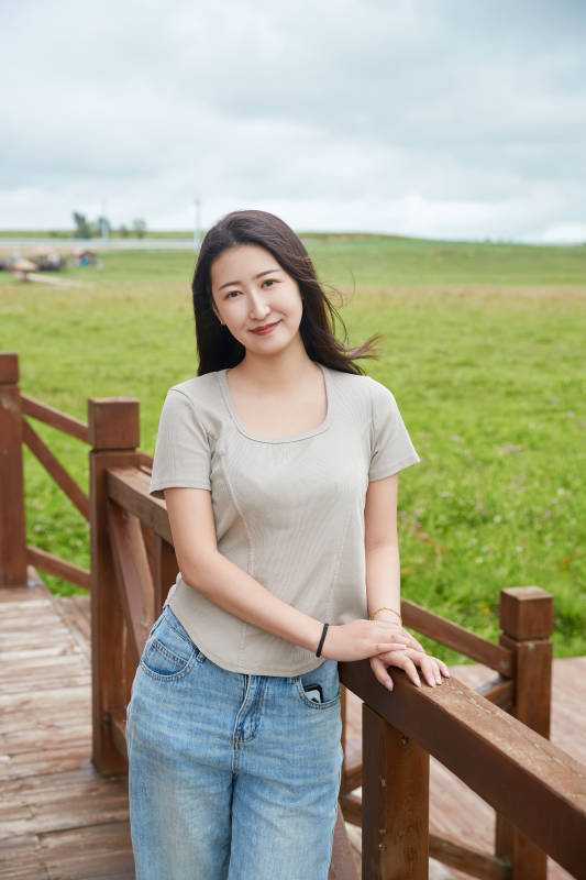 盛夏在草原花海拍照游玩的美女图片