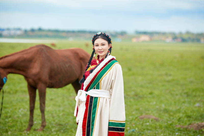 身穿藏族服饰和马匹拍照的美女图片