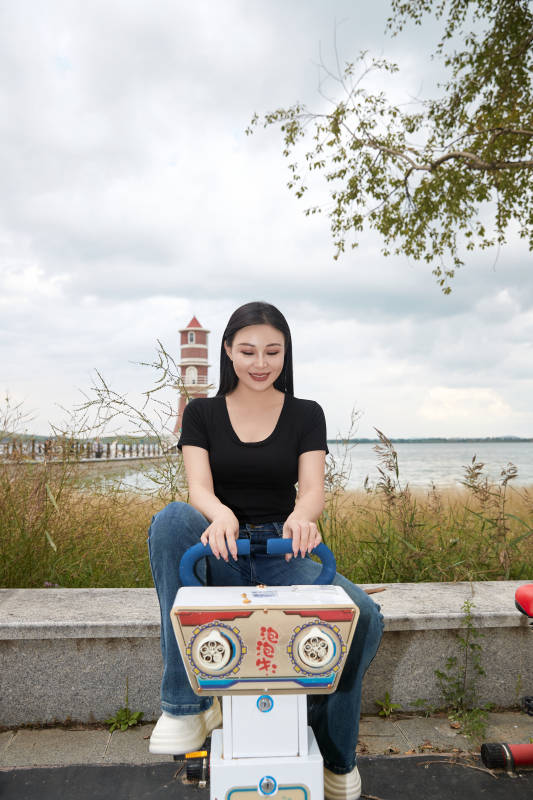 坐在泡泡瑶瑶车上的美女图片