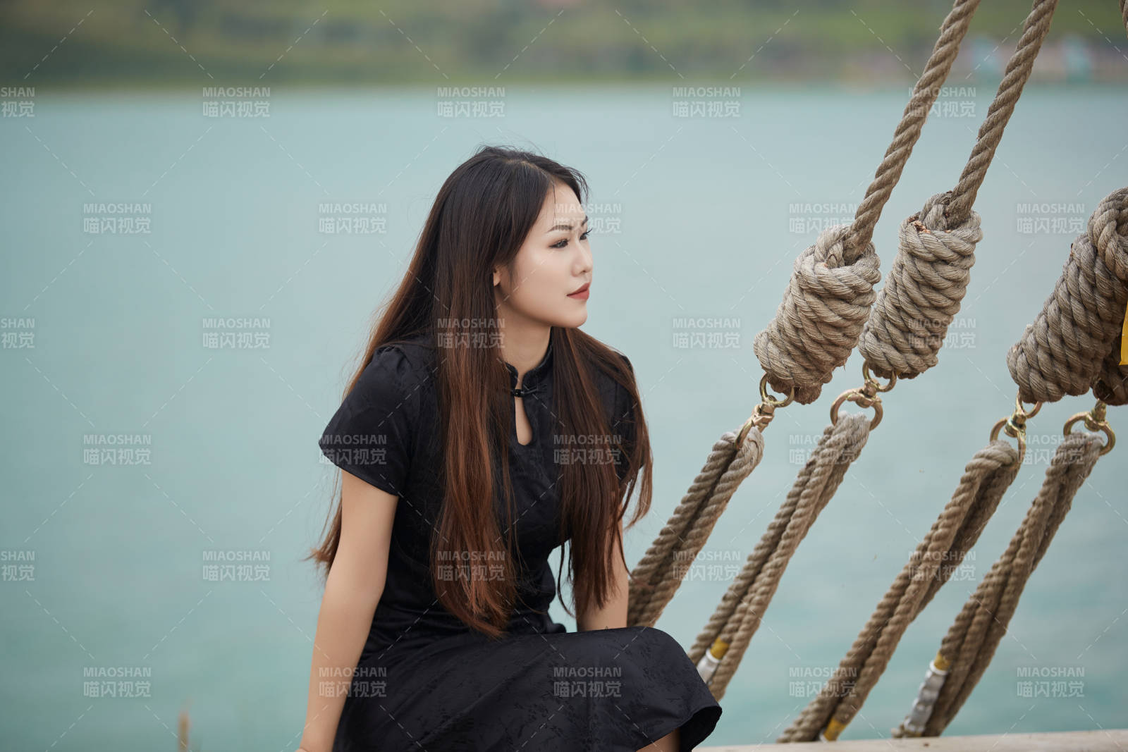 在湖畔木制帆船上拍照游玩的亚洲女性图片