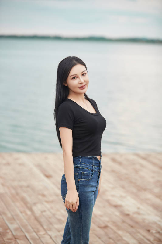 盛夏在草原湿地公园拍照游玩的美女图片