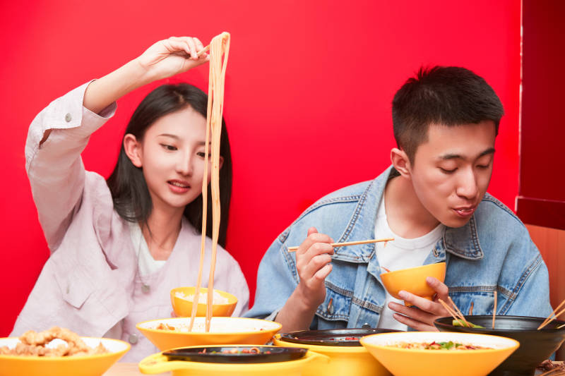 餐厅里吃饭的年轻情侣图片