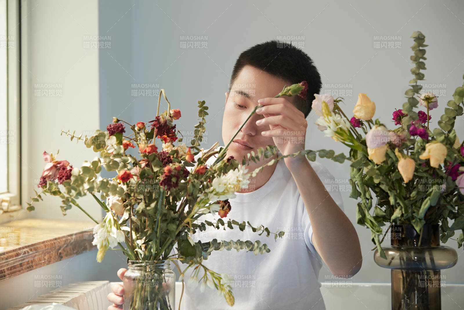 摆弄插花的帅气男青年图片