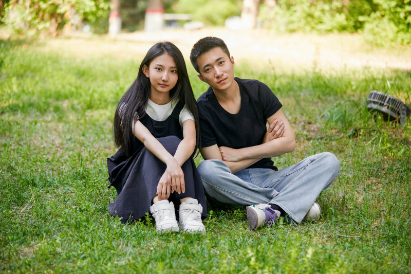 户外草坪上的恩爱年轻情侣图片