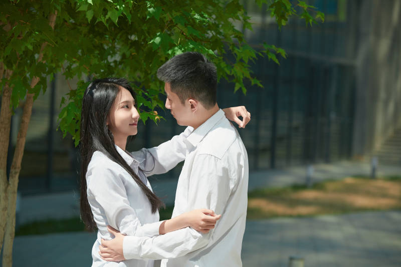 坐在户外台阶上的青年情侣图片