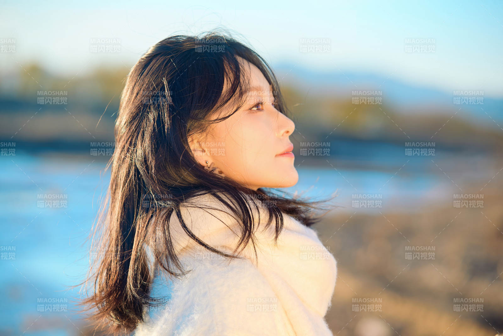 秋天在夕阳下的原野河边拍照的美女图片