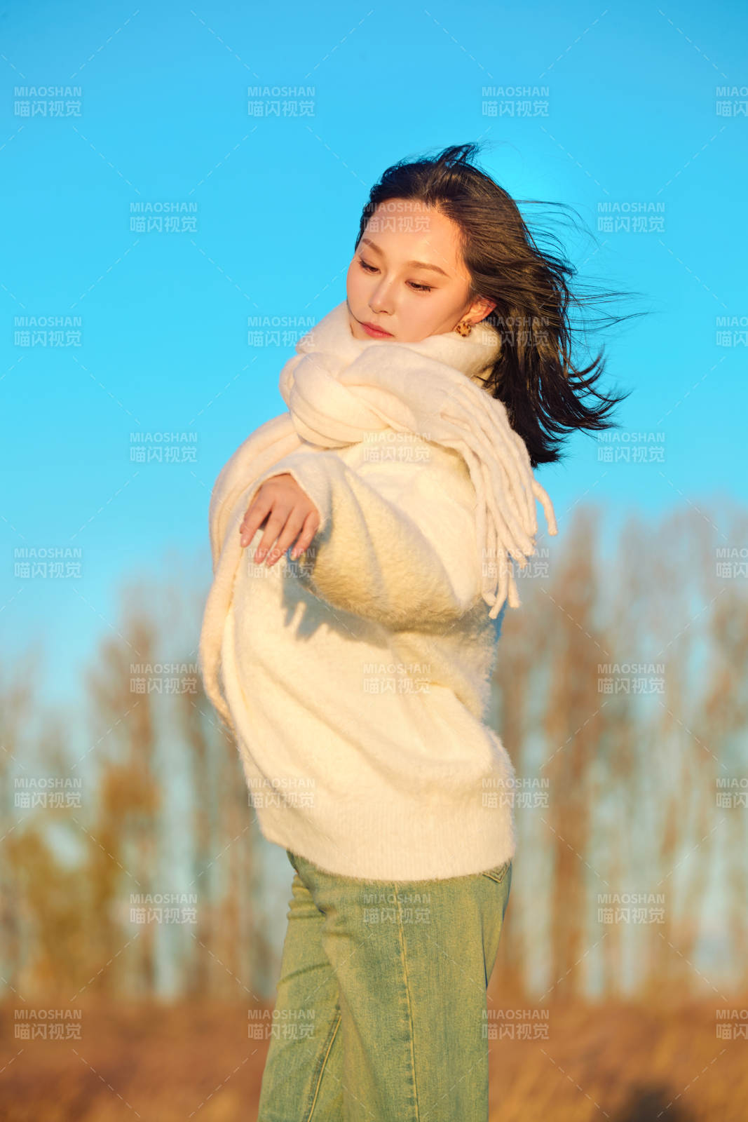 深秋夕阳下在户外河水边的东方女性图片