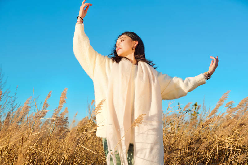 秋天晴朗的午后在芦苇荡里起舞的美女图片