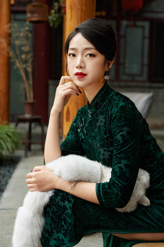 在中式庭院里身穿复古旗袍的亚洲女性图片