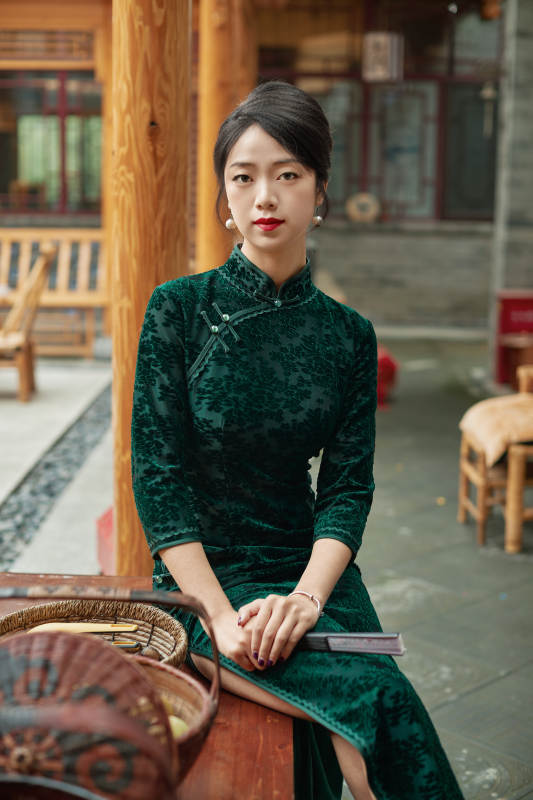 坐在中式庭院里身穿复古旗袍的亚洲女性图片