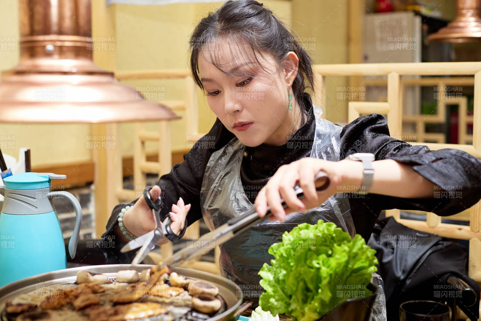 在韩式烤肉店享受美食的亚洲美女图片