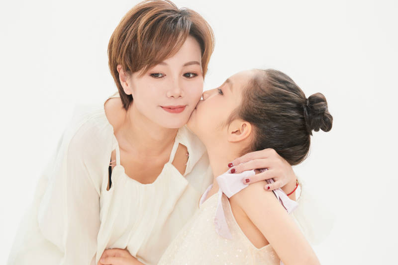 白色背景里的美丽妈妈与可爱女儿亲子人像图片