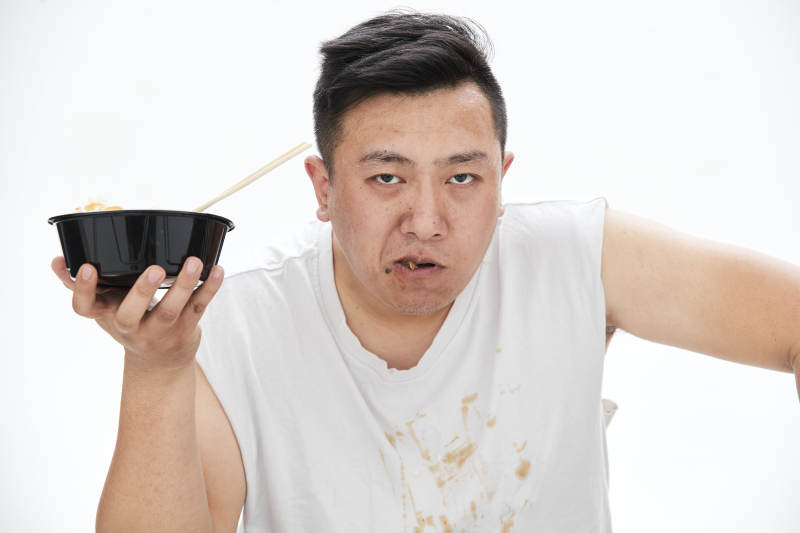 大吃特吃各种食物的肥胖亚洲男子图片