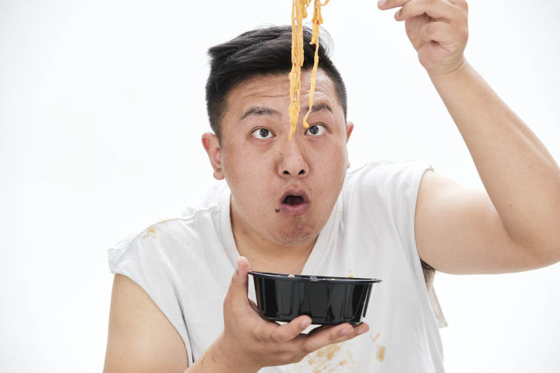 大吃特吃各种食物的肥胖亚洲男子图片