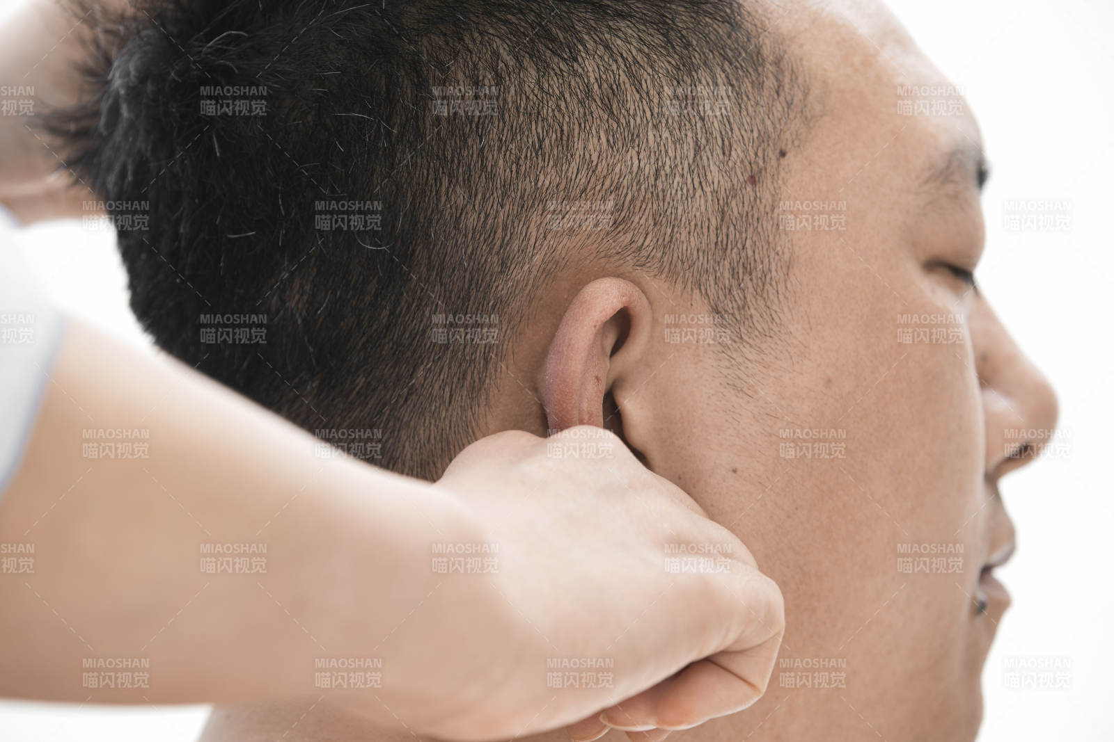 专业按摩师为男子进行头部按摩图片