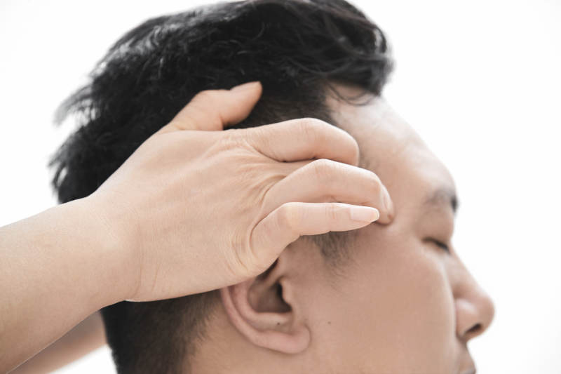 专业按摩师为男子进行头部按摩图片