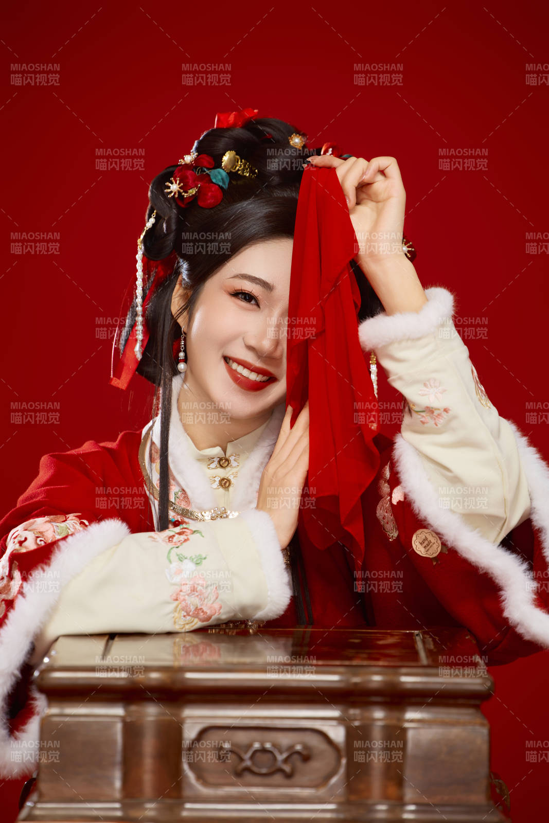 喜庆红色背景下身穿中国汉服的年轻女性图片