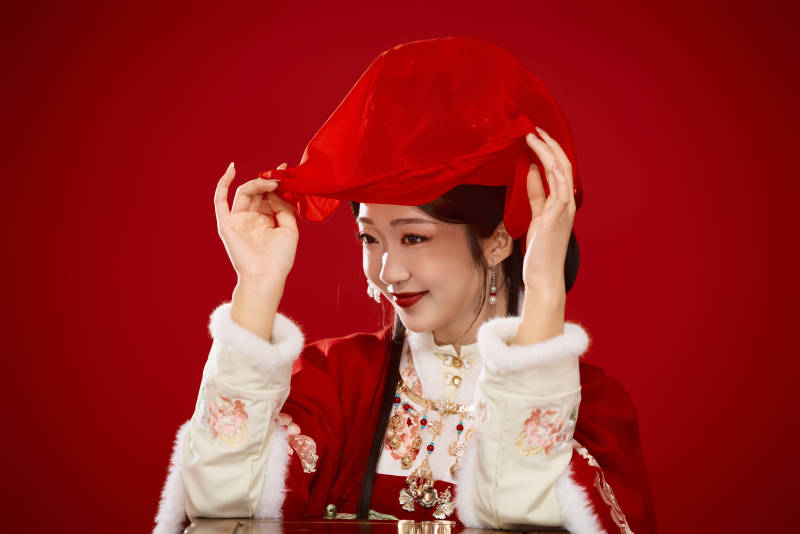 喜庆红色背景下身穿中国汉服的年轻女性图片