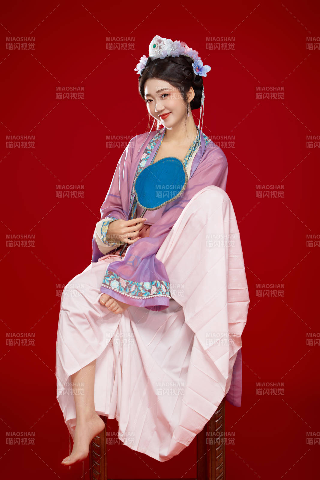 红色背景下身穿中国明朝簪花发饰汉服的美女图片