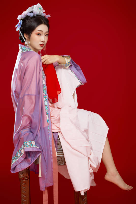 红色背景下身穿中国明朝簪花发饰汉服的美女图片