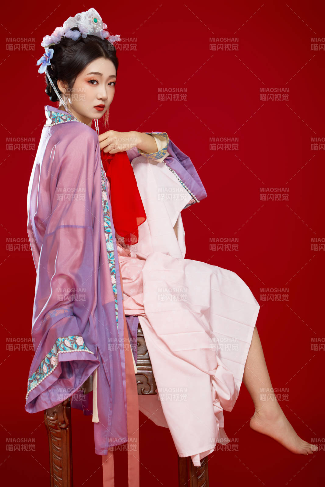 红色背景下身穿中国明朝簪花发饰汉服的美女图片