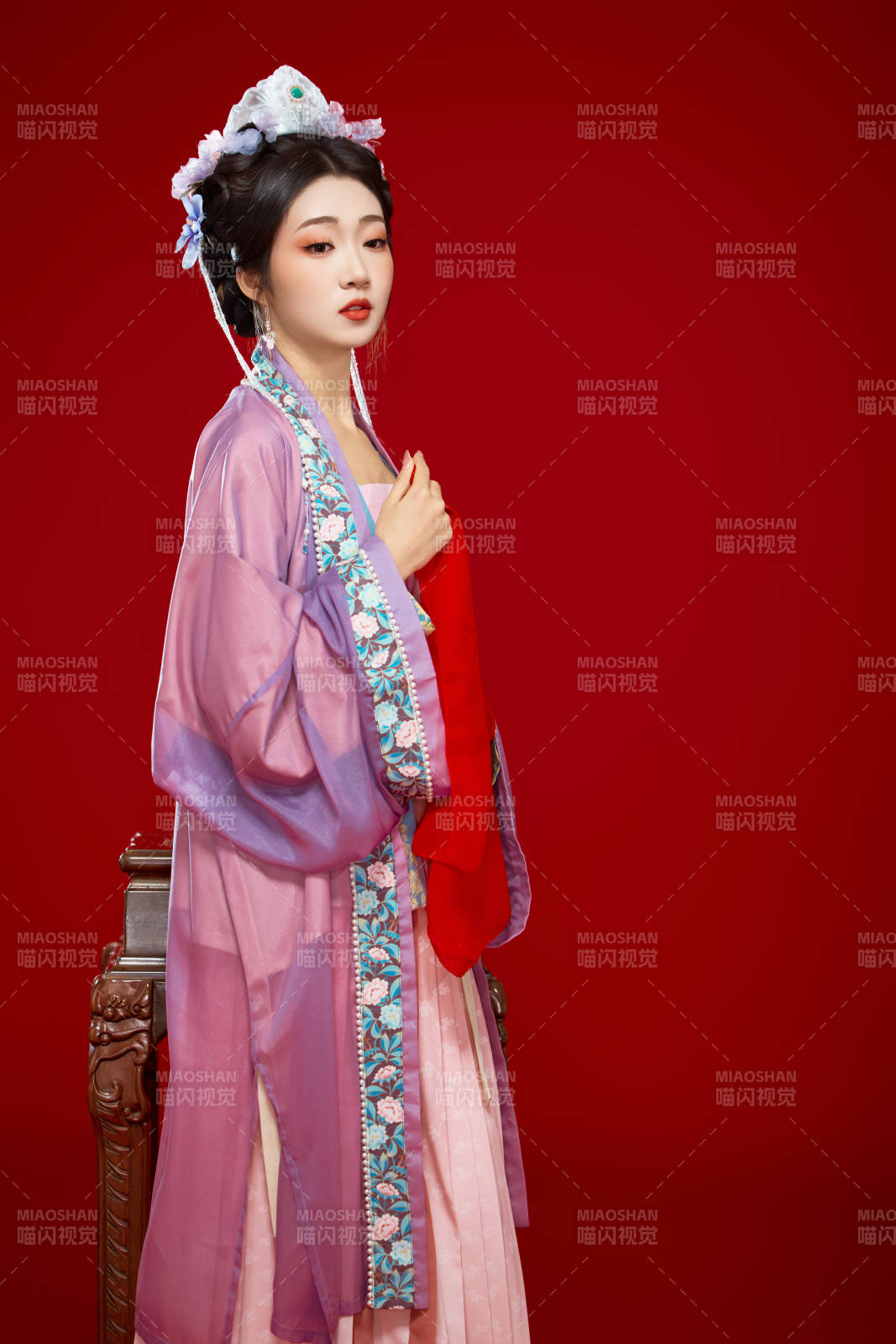 红色背景下身穿中国明朝簪花发饰汉服的美女图片