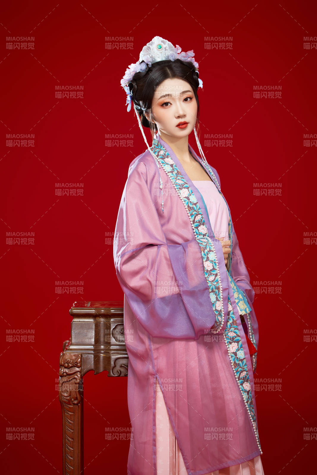 红色背景下身穿中国明朝簪花发饰汉服的美女图片