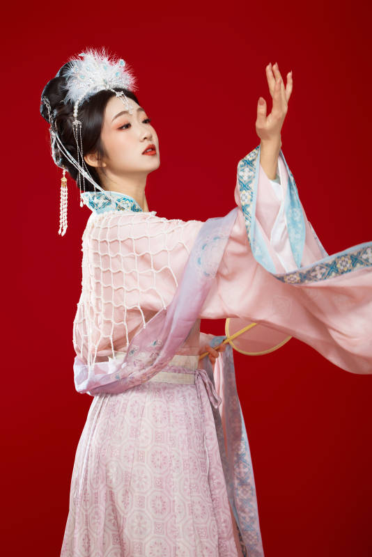 红色背景下身穿中国明朝簪花发饰汉服的美女图片