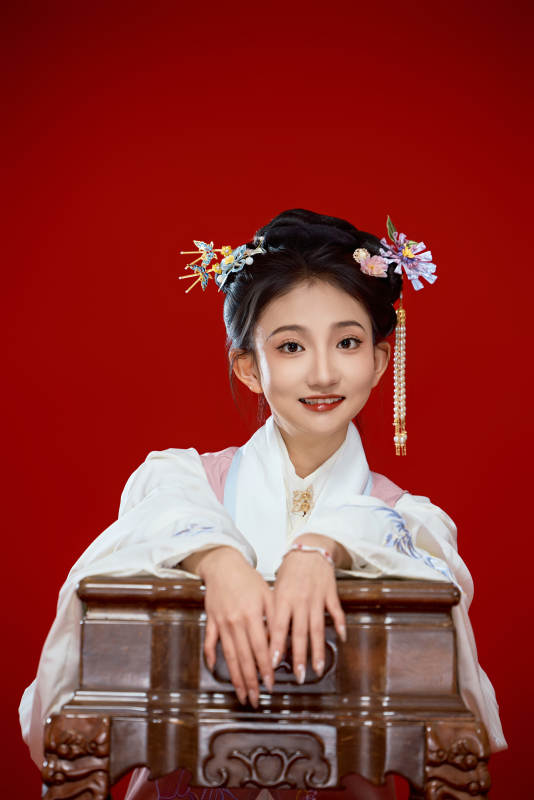 红色背景下穿着中国明朝明制汉服服饰的少女图片