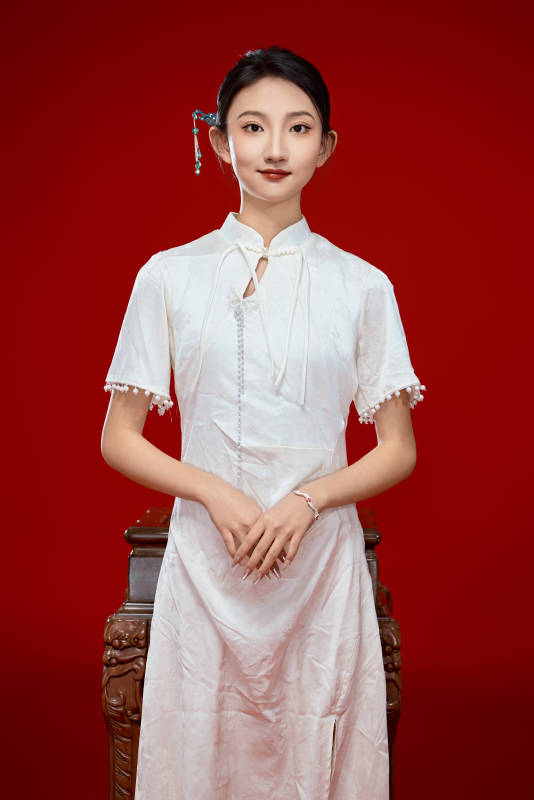 红色背景下穿着中式传统旗袍的美丽少女图片