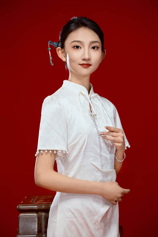 红色背景下穿着中式传统旗袍的美丽少女图片