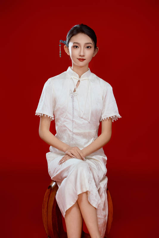 红色背景下穿着中式传统旗袍的美丽少女图片