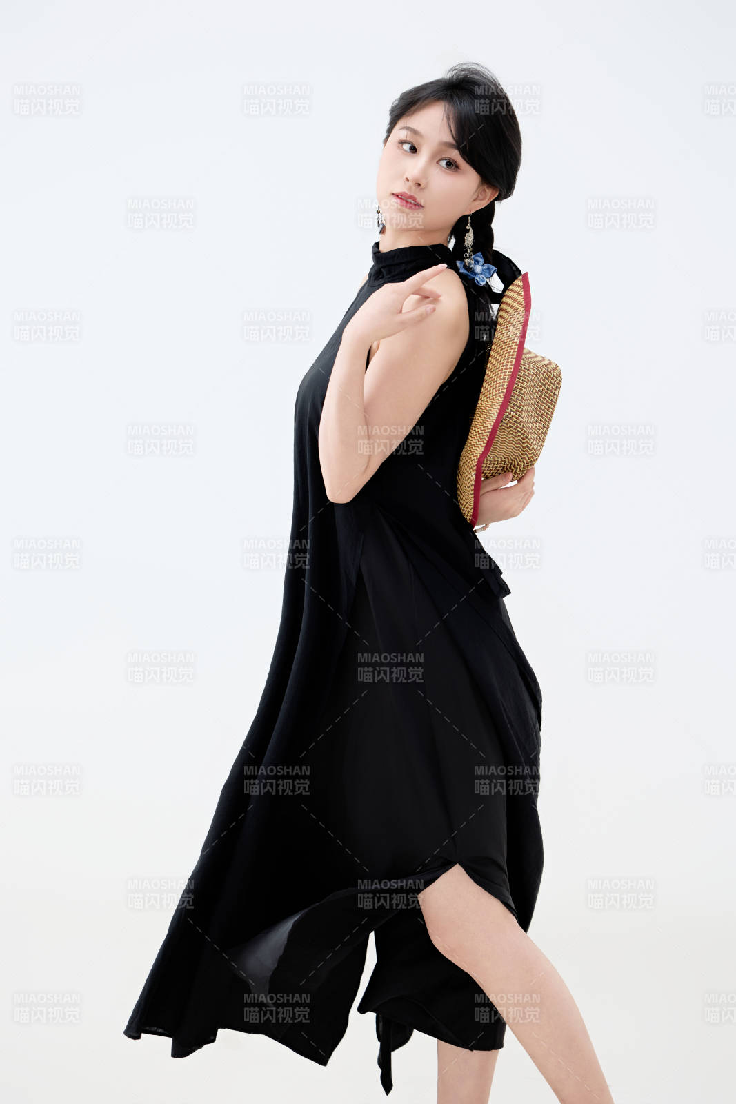 影棚拍摄穿着黑色连体裙的夏日出行美女图片