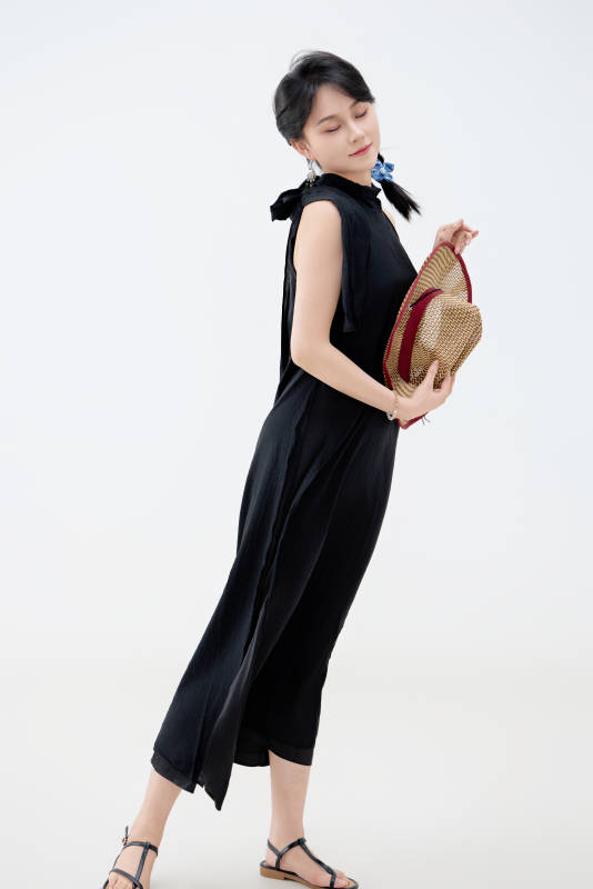 影棚拍摄穿着黑色连体裙的夏日出行美女图片