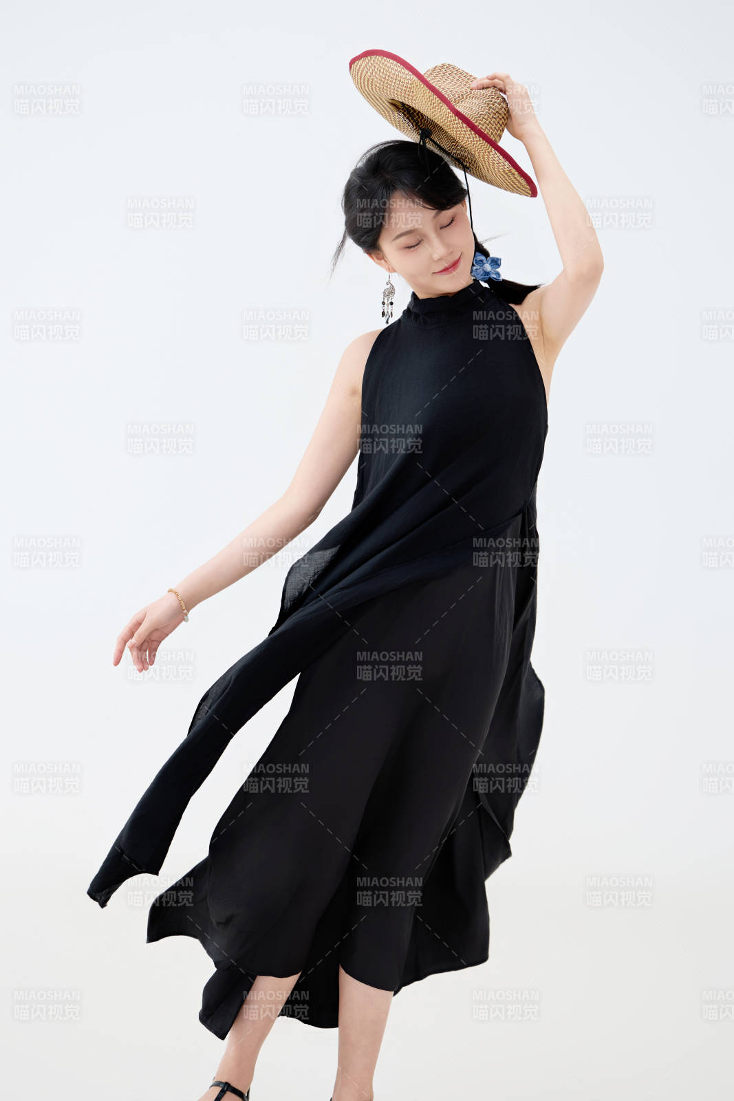 影棚拍摄穿着黑色连体裙的夏日出行美女图片