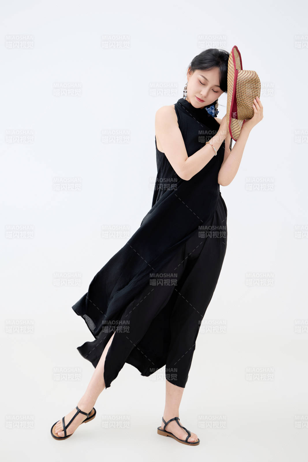 影棚拍摄穿着黑色连体裙的夏日出行美女图片