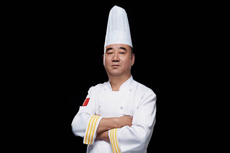 黑色背景下的酒店行政主厨形象图片