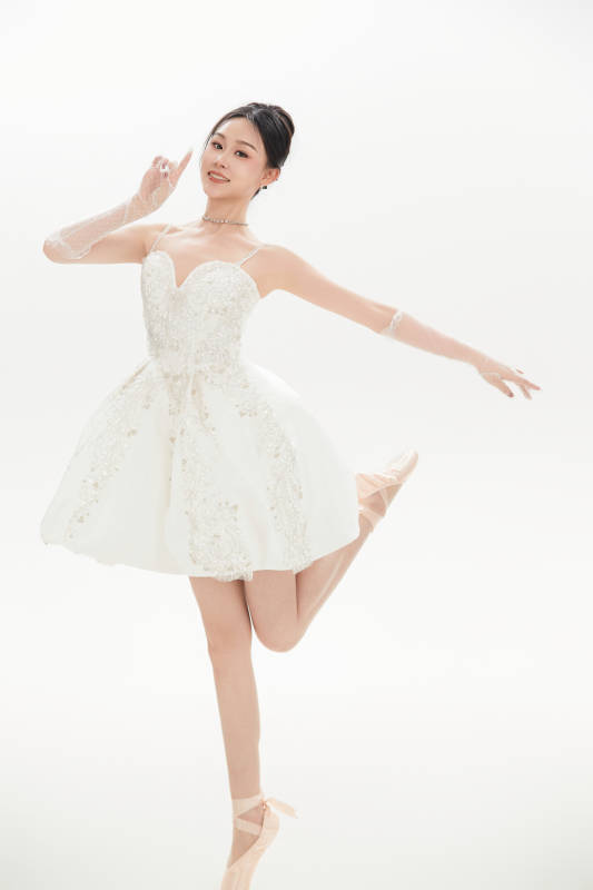 白色背景下跳芭蕾舞的亚洲少女图片