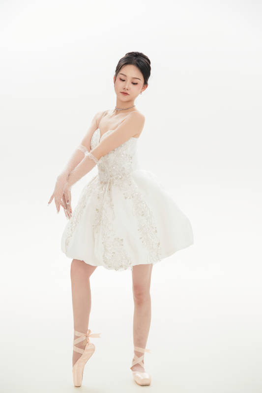 白色背景下跳芭蕾舞的亚洲少女图片