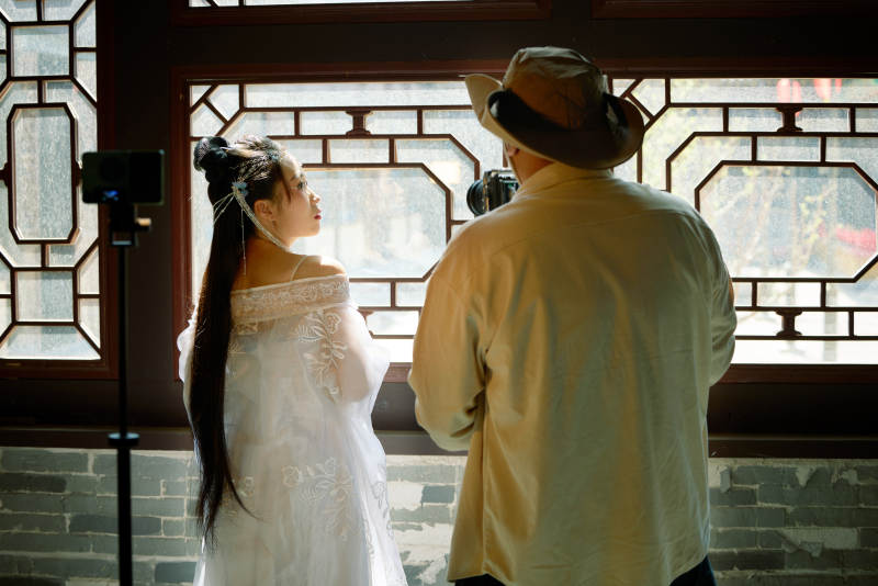 穿着汉服在古城拍照的东方美女图片