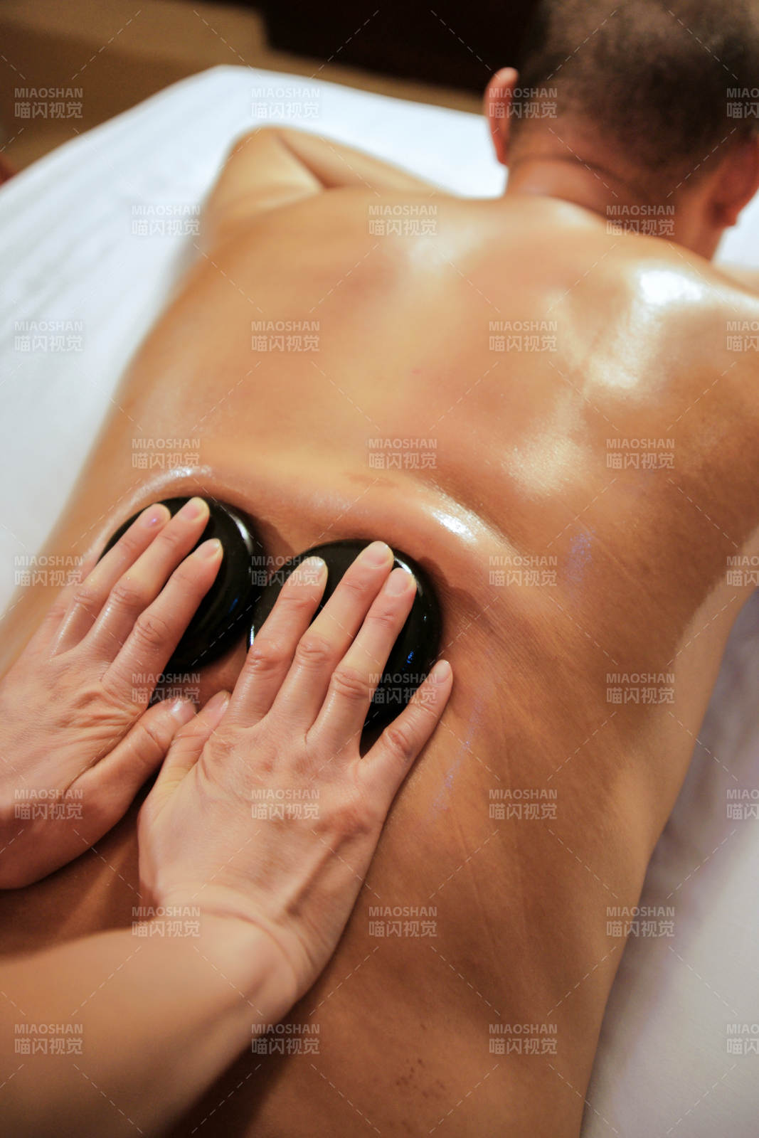 专业的按摩技师为顾客进行玉石推拿图片